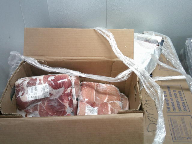 Packs of different meats in a cardboard box.